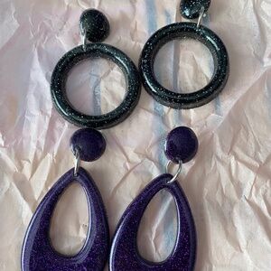 Pair of black and purple earrings